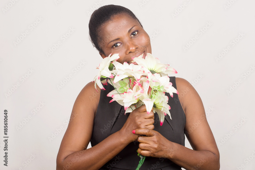 happy woman holding flowers and a card happy woman holding flowers and a card
