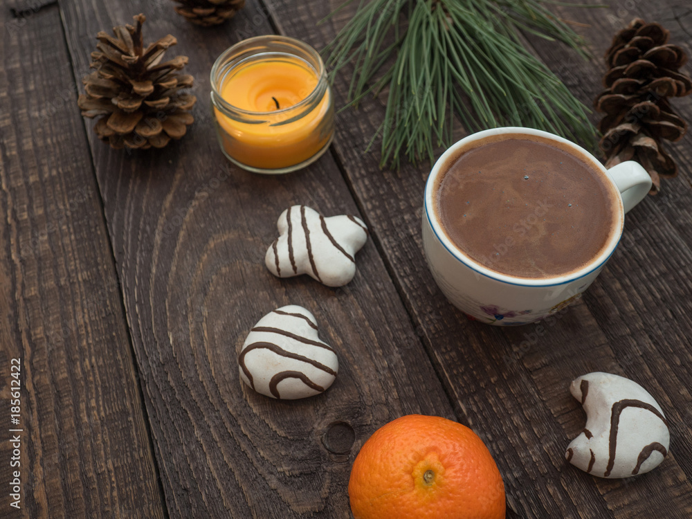 Cup of cocoa with foam and gingerbread on a wooden table Cup of cocoa with foam and gingerbread on a wooden table