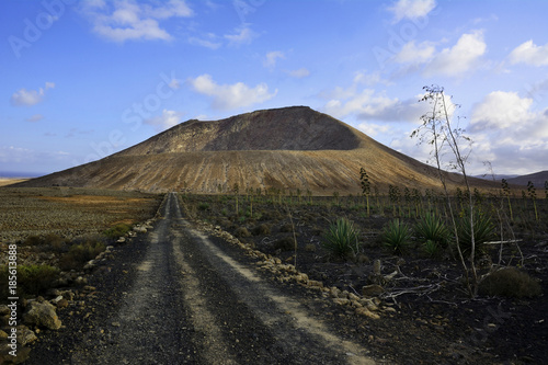 Ein Feldweg der zu einem erloschenen Vulkan hinführt.

