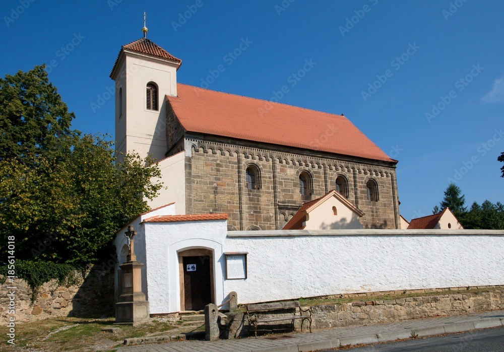 Fototapeta premium Cemetery and romanesque church St. Nicholas in the village Potvorov,Western Bohemia, Czech republic, Europe
