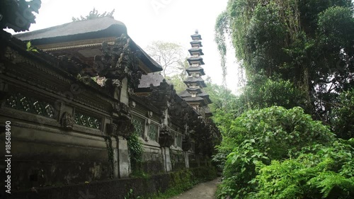 Wall of the temple Pura Gunung Lebah with pagoda Ubud, Bali, Indonesia photo