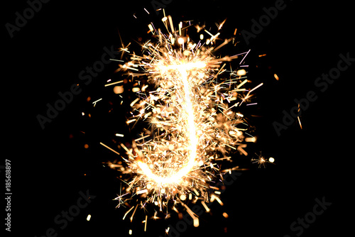 Letter "J" made of sparklers isolated background.