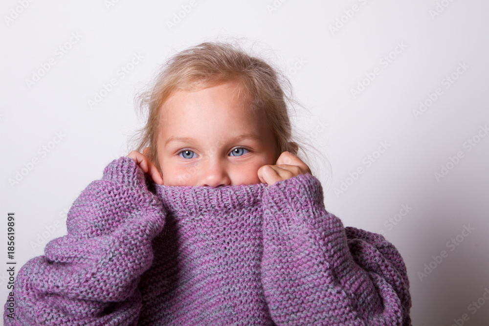 happy beautiful little girl wore a knitted lilac mom's sweater happy beautiful little girl wore a knitted lilac mom's sweater