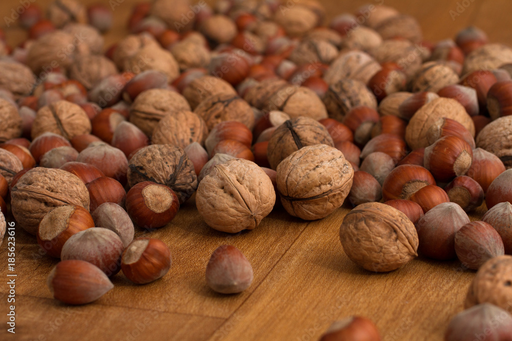 walnuts and hazelnuts scattered on dark boards, background walnuts and hazelnuts scattered on dark boards, background