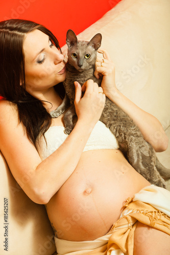 Adult woman showing her pregnant belly photo