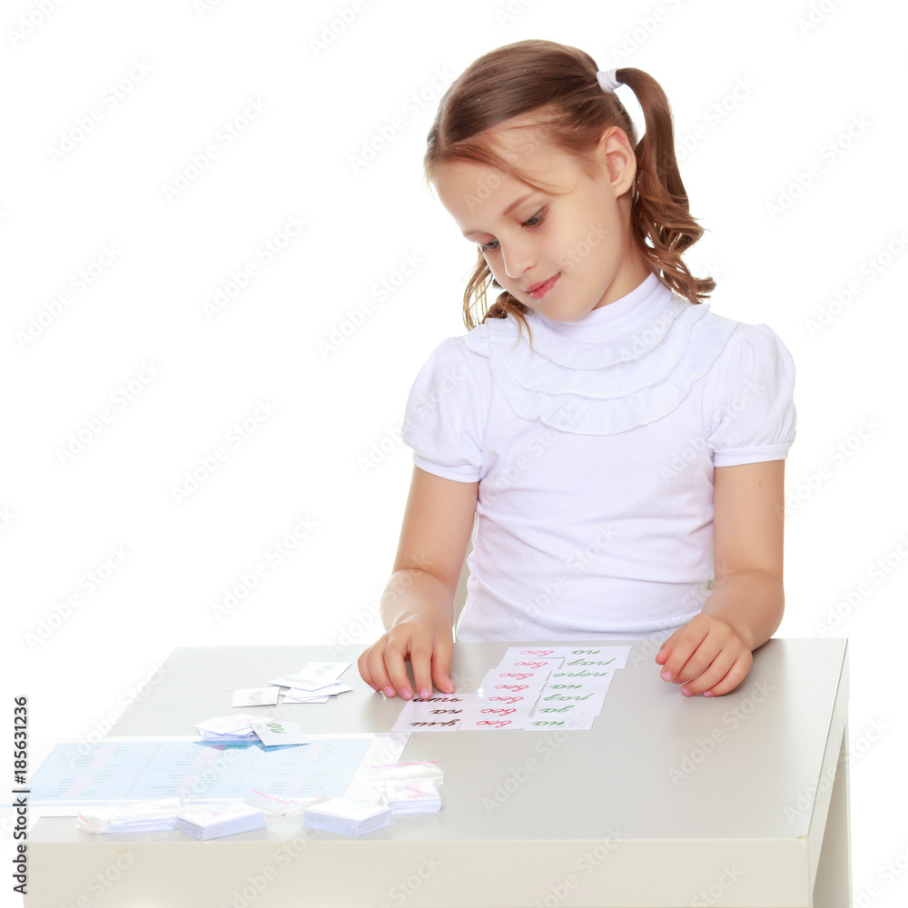 A little girl is studying Montessori stuff. A little girl is studying Montessori stuff.