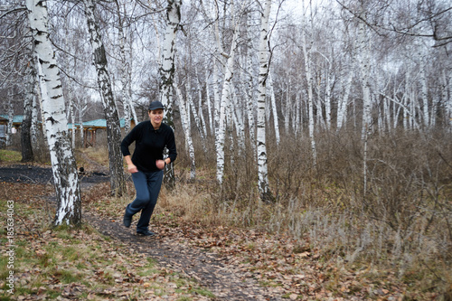 a woman runs in the woods
