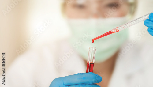 Female Technician work on blood tube test  a rack of  blood samples Tubes of patients in laboratory in the hospital.