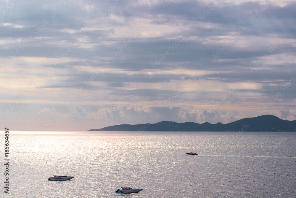 Boats in the sea while sunset making two tone sky Boats in the sea while sunset making two tone sky
