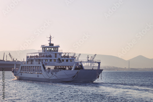 A large white ferry floats away into the distance. Water trail. Greece. © 008melisa