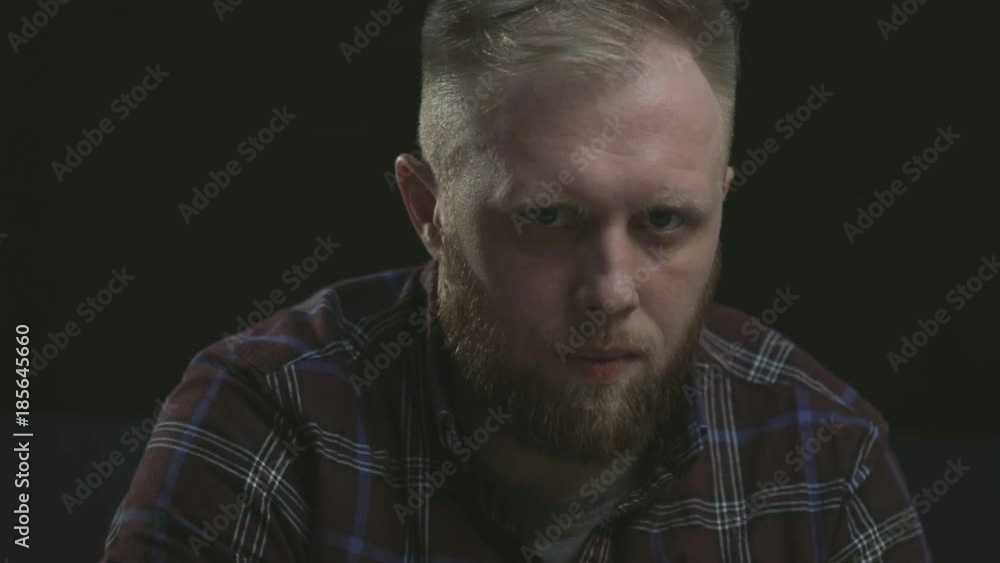 serious concentrated stylish bearded man looking at oncoming approaching camera (zoom), wering plaid shirt. Strong character serious concentrated stylish bearded man looking at oncoming approaching camera (zoom), wering plaid shirt. Strong character