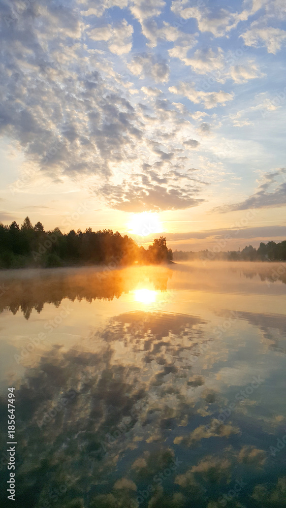 Sunrise on the forest lake