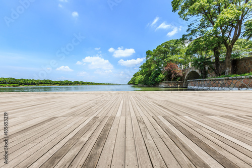 wooden board observation deck and lake landscape in city park © ABCDstock