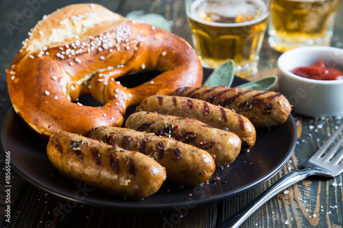 Fried sausages and salted pretzel. Snack to beer