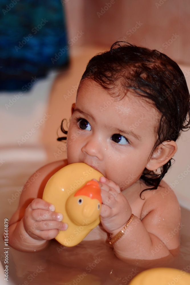 Lovely little girl taking bath and playing with her rubber duckie Lovely little girl taking bath and playing with her rubber duckie
