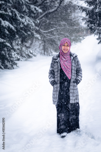 A pregnant woman from Asia pose outdoor during winter in Canada