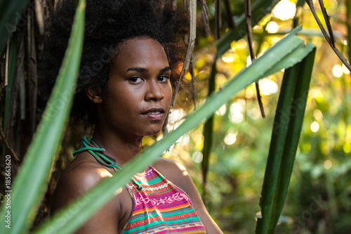 Foto Melanesian pacific islander athlete girl with afro hair style in the jungle, hal