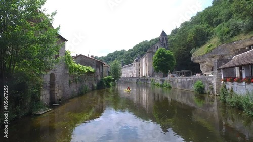 Beautiful travelling shot of Brantome in France, filmed from the river photo