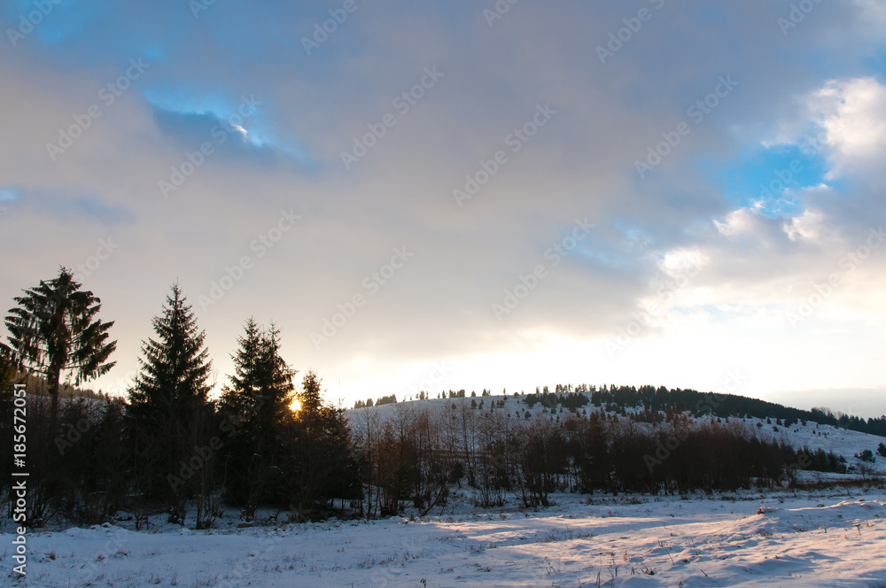Winter landscape at sunset near a pine forest in Romania. Winter landscape at sunset near a pine forest in Romania.