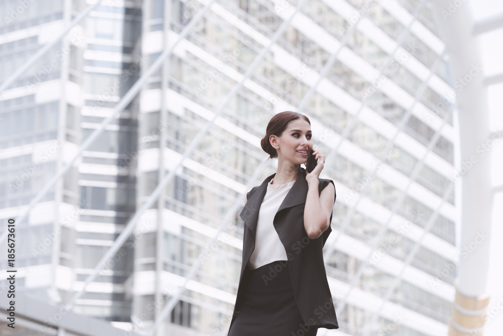 Two beautiful confident business woman talking on phone together. Two beautiful confident business woman talking on phone together.
