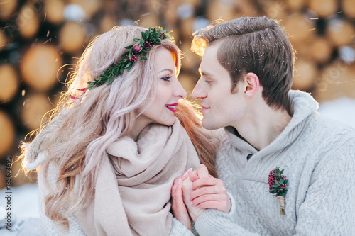 Couple in love warms each other's hands. Winter wedding. Close-up portrait of Beautiful newlyweds.