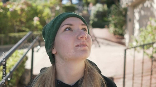 gimbal shot of teen girl standing on Lombard street in daytime