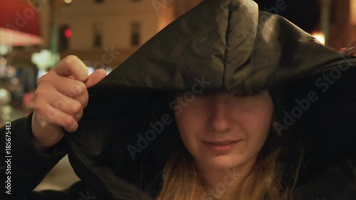 gimbal shot of teen girl standing on street of Chinatown in San Francisco at night