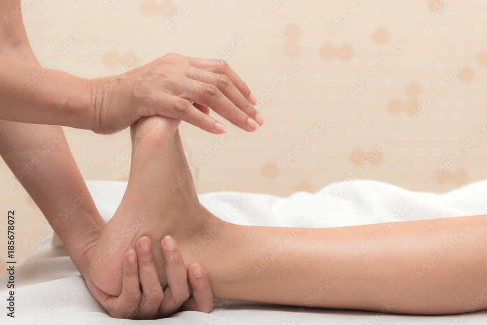 Asian exotic holiday spa concept. Beautiful young white woman enjoy relaxing during foot massage at spa, taken indoor in real spa location. Asian exotic holiday spa concept. Beautiful young white woman enjoy relaxing during foot massage at spa, taken indoor in real spa location.