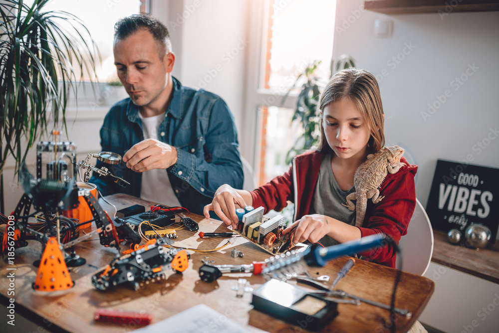 Father and daughter building robot Father and daughter building robot