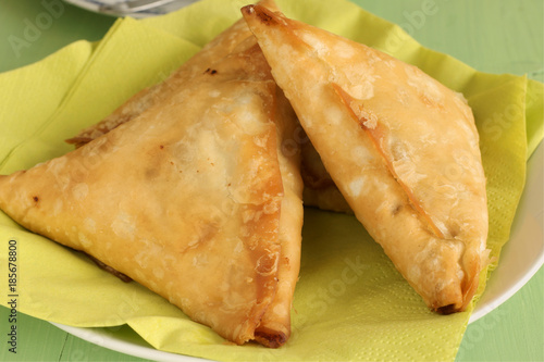 Samosas a spicy blend of vegetables or meat in a deep fried pastry parcel photo