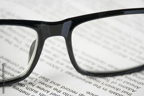 Close up view of a glasses on the open book (concept, background)