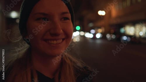 gimbal shot of teen girl standing on street of Chinatown in San Francisco at night
