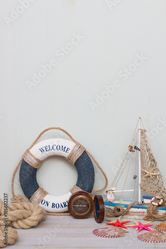 Copy space with lifebuoy, compass, boat, starfish and rope. Vacation on the sea.