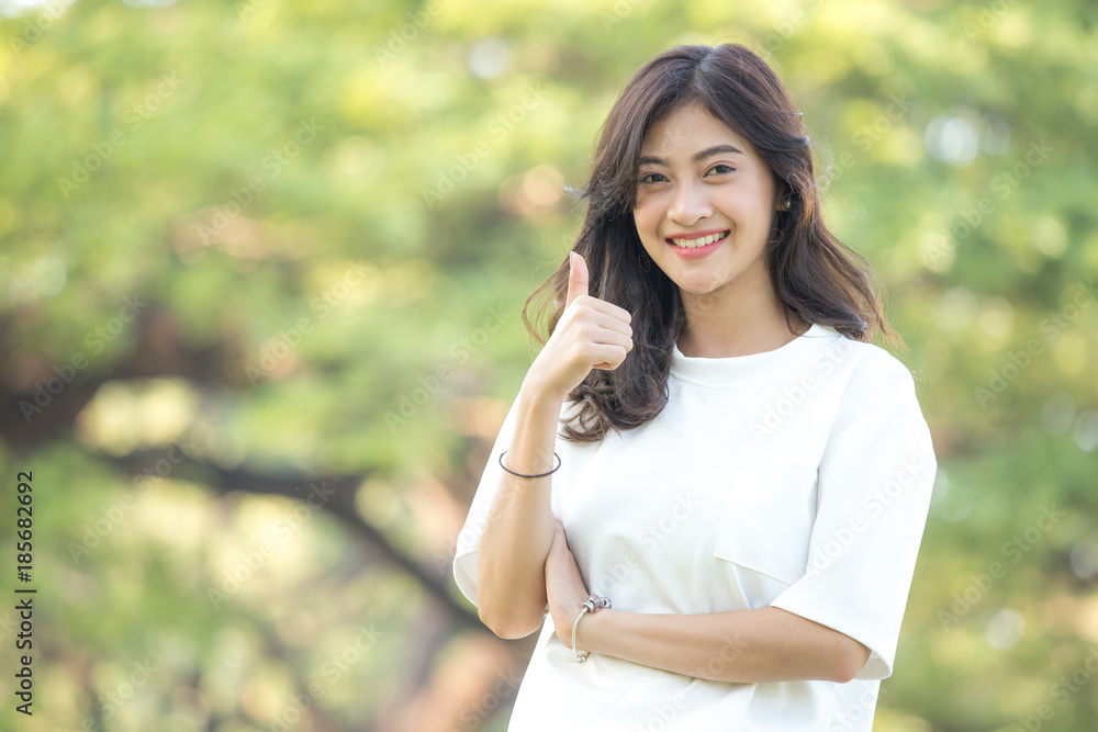 Beautiful young Asian woman smiling in the park. Outdoor portrait Beautiful young Asian woman smiling in the park. Outdoor portrait
