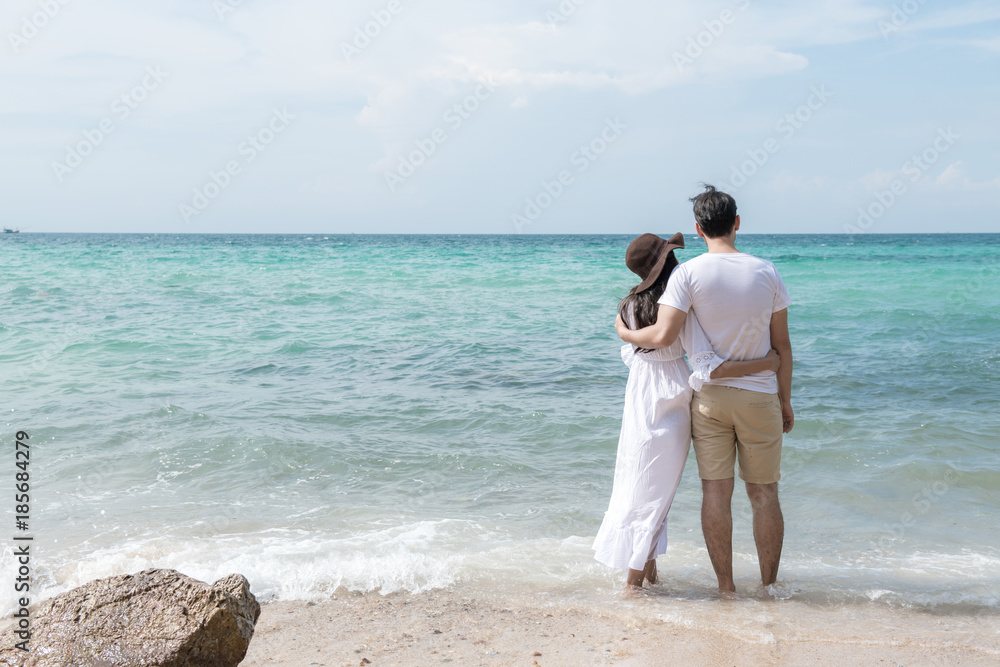 Couple holding each other on beach. Young happy interracial couple on beach holding each other. Asian woman, Caucasian man. Young mixed race romance concept. Couple holding each other on beach. Young happy interracial couple on beach holding each other. Asian woman, Caucasian man. Young mixed race romance concept.