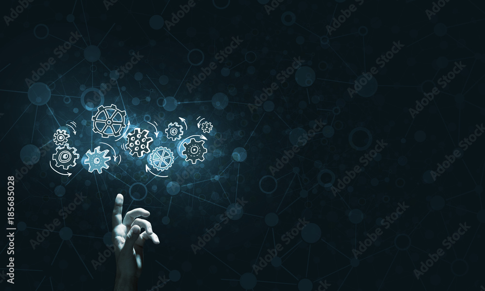 Glowing cogwheel mechanism icon on dark background as symbol of teamwork Glowing cogwheel mechanism icon on dark background as symbol of teamwork
