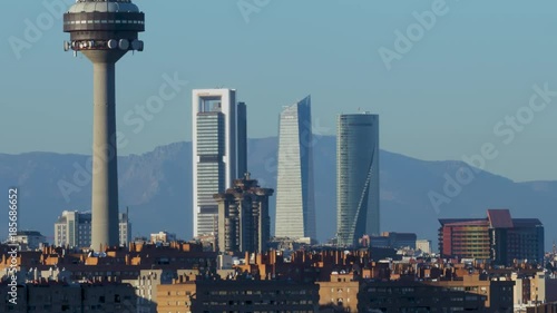 Panoramic of the city with the skyline, communications tower and mountain in the background. madrid spain at sunset