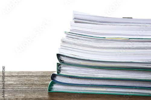 Stack of documents on table against white background