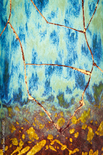 A vase that is in the process of being repaired using the Japanese art form of kintsugi.