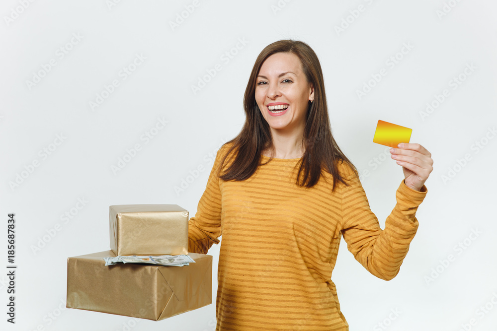 Beautiful caucasian smiling young happy birthday woman in yellow clothes holding credit card, lot of cash money, golden gift boxes with present, celebrating holiday party on white background isolated. Beautiful caucasian smiling young happy birthday woman in yellow clothes holding credit card, lot of cash money, golden gift boxes with present, celebrating holiday party on white background isolated.