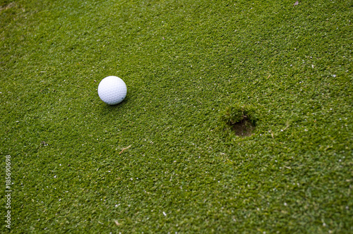 Golf ball on green with ball mark