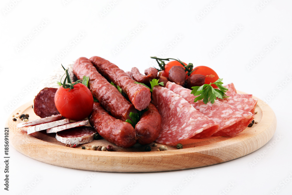 Food tray with delicious salami, pieces of sliced ham, sausage, tomatoes, salad and vegetable - Meat platter with selection - Cutting sausage and cured meat