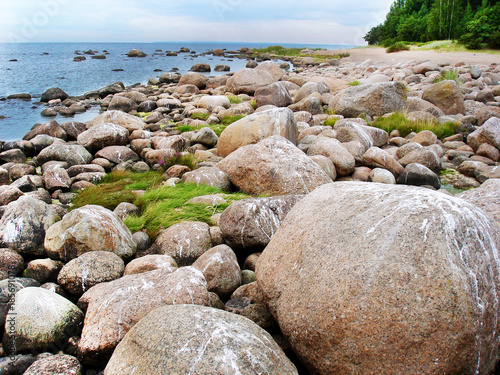 Stone boulders on the beach of the northern sea.