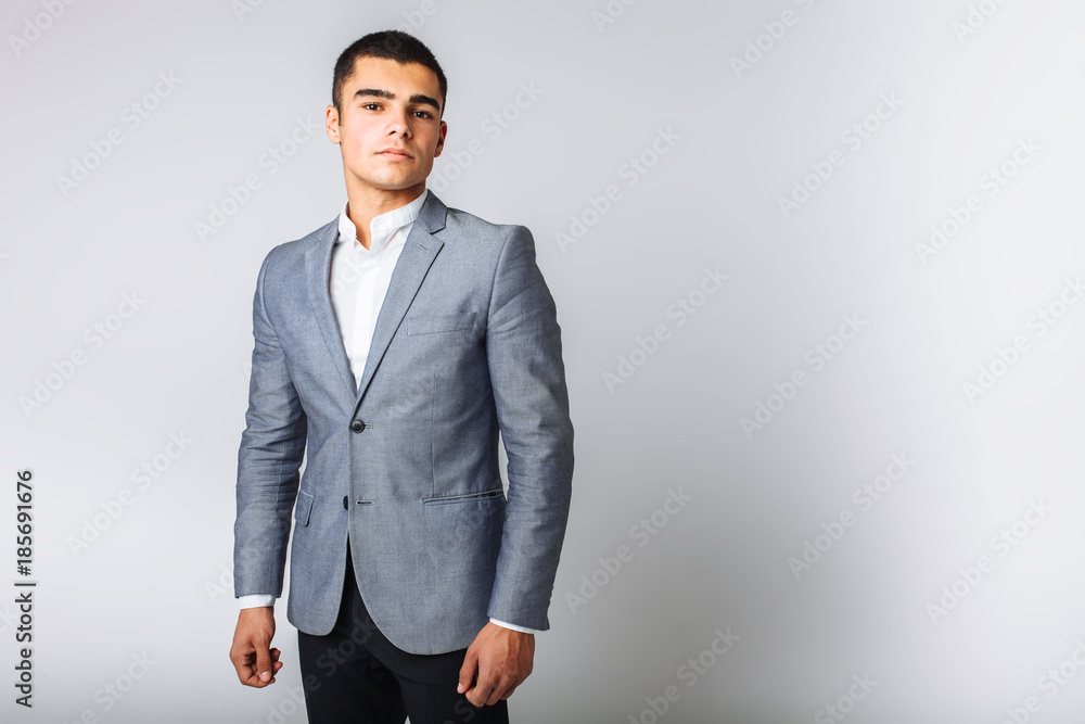 Portrait of the beautiful posing in a Studio, White background, Stylish business man Portrait of the beautiful posing in a Studio, White background, Stylish business man