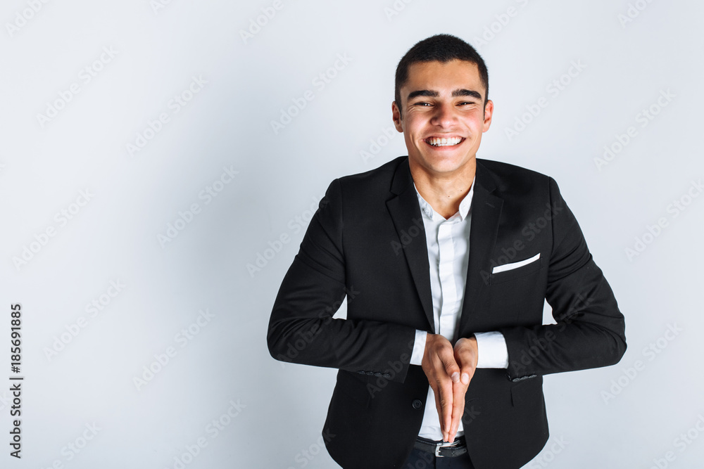 The man in the Studio, put his hands in the palms, stylish in a suit. A man prays or asks about something The man in the Studio, put his hands in the palms, stylish in a suit. A man prays or asks about something