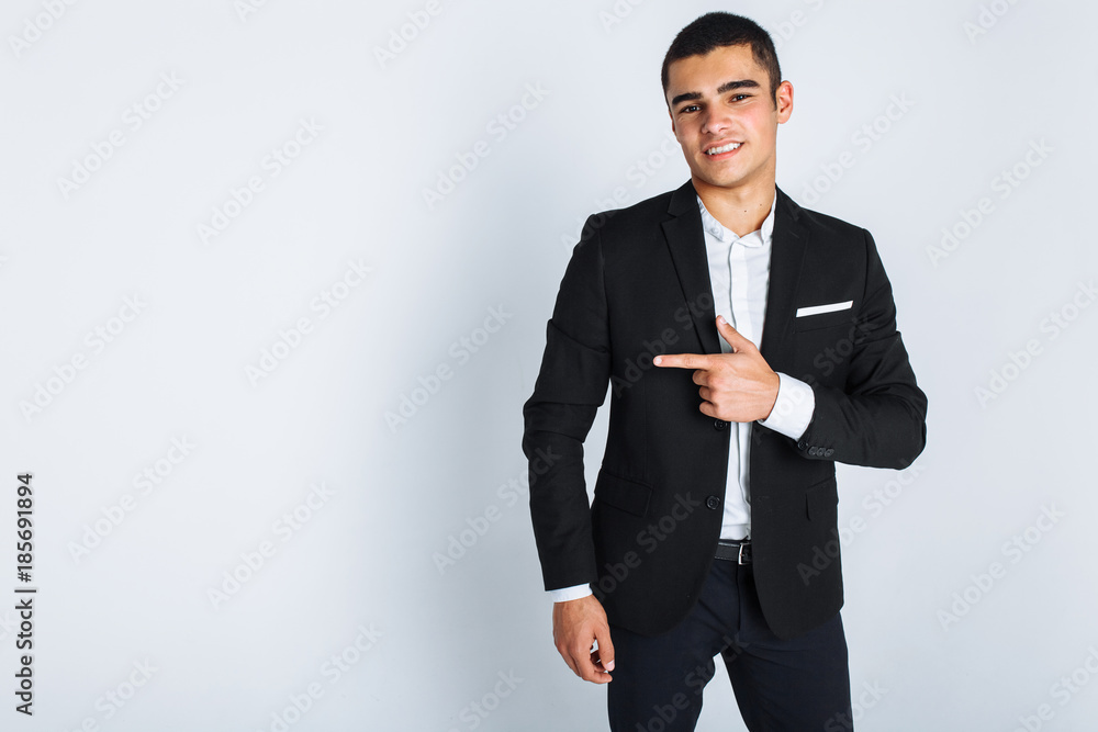 Stylish man pointing finger on isolated background of a beautiful smiling guy Stylish man pointing finger on isolated background of a beautiful smiling guy