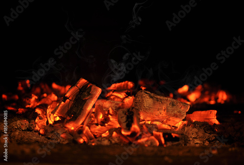Smoldering embers in the fireplace photo