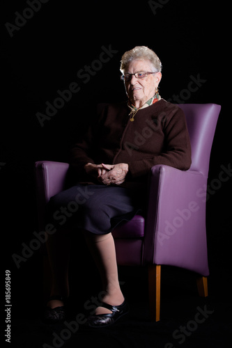 Portrait of a Grandmother with glasses smiling to the camera