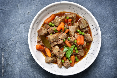 Meat stew with carrot and green pea.Top view.