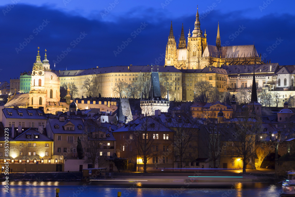 Obraz premium Night colorful snowy Christmas Prague Lesser Town with gothic Castle and Charles Bridge, Czech republic